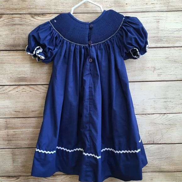 SMOCKED A LOT SMOCKED DRESS WITH EMBROIDERED NATIVITY SCENE - Picture 2 of 7